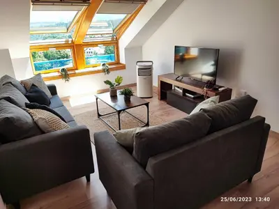 a living room with two couches and a flat screen tv at Mondariz Donde el Agua es Vida in Mondariz