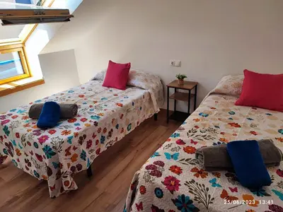 a bedroom with two beds with pillows at Mondariz Donde el Agua es Vida in Mondariz