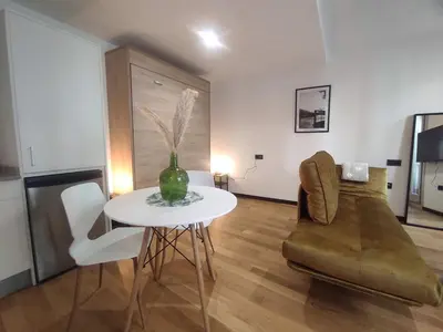a living room with a table and a couch at 1A. Estudio para disfrutar y tapear en Ourense in Ourense