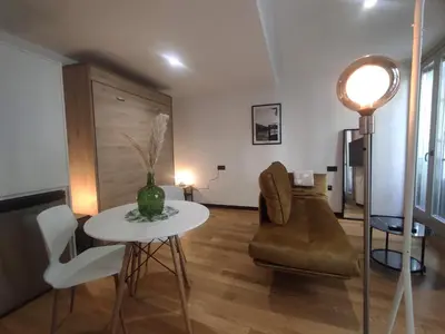 a living room with a table and a couch at 1A. Estudio para disfrutar y tapear en Ourense in Ourense