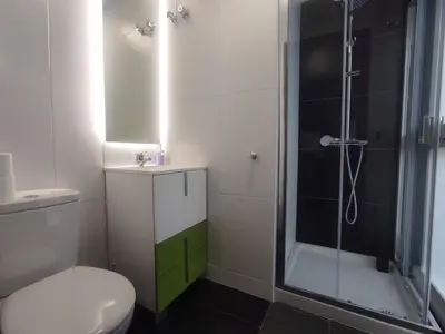 a bathroom with a toilet and a glass shower at 1B. Estudio muy luminoso en el corazón del tapeo. in Ourense