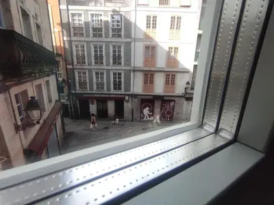 a view from a window of a street with buildings at 1B. Estudio muy luminoso en el corazón del tapeo. in Ourense