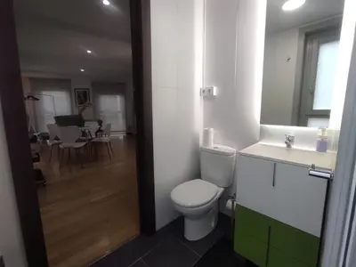 a bathroom with a white toilet and a sink at 1B. Estudio muy luminoso en el corazón del tapeo. in Ourense