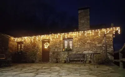 a stone building with lights on it at night at Casa da Costa de Sueiro in Sueiro