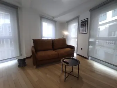 a living room with a couch and a table at 2. Luminoso y único en la mejor zona gastronómica in Ourense
