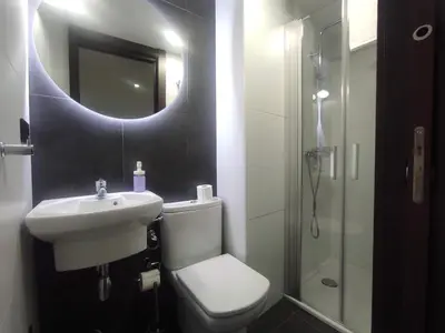 a bathroom with a sink and a toilet and a mirror at 2. Luminoso y único en la mejor zona gastronómica in Ourense