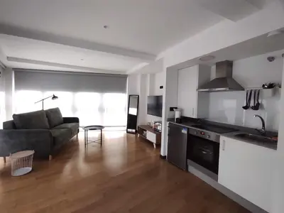 a kitchen and living room with a couch and a table at 3. Amplio y muy luminoso para disfrutar de Ourense in Ourense
