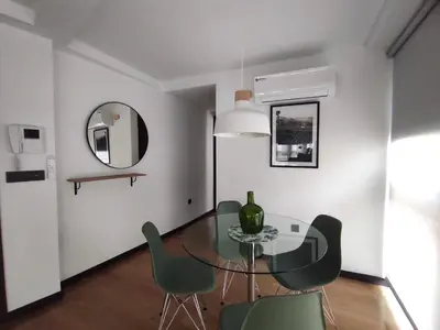 a dining room with a glass table and green chairs at 3. Amplio y muy luminoso para disfrutar de Ourense in Ourense