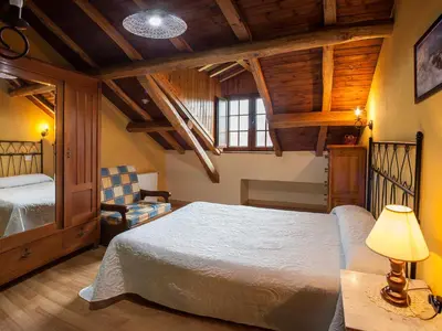 a bedroom with a bed and a lamp and a chair at Casa de Aldea Carboneiro in Naraval