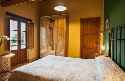 a bedroom with a large bed and a window at Casa de Aldea Carboneiro in Naraval