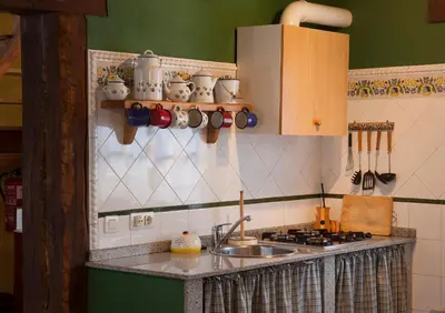 a kitchen with a sink and a counter with pots and pans at Casa de Aldea Carboneiro in Naraval