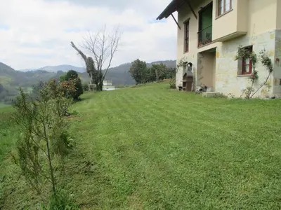 a house on the side of a grass field at Casa de Aldea Carboneiro in Naraval