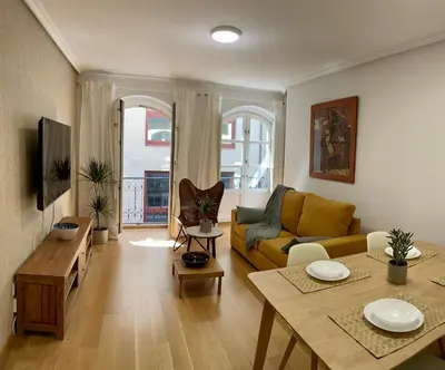 a living room with a couch and a table at Piso Principal in Ourense