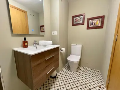 a bathroom with a sink and a toilet at Piso Principal in Ourense