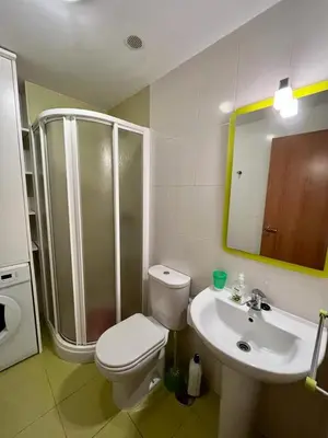 a bathroom with a shower and a toilet and a sink at Playa grande Miño travesía in Miño