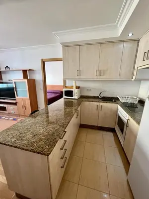 a kitchen with a large counter top in a room at Playa grande Miño travesía in Miño