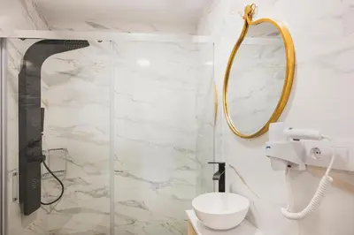 a bathroom with a shower and a toilet and a mirror at Apartamentos Luis in Arzúa