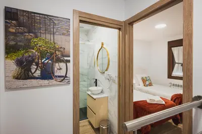 a bathroom with a bike painting on the wall at Apartamentos Luis in Arzúa