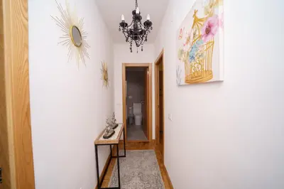 a hallway with a table and a chandelier at Antoxos Sacra Home II in Chantada