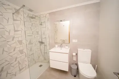 a bathroom with a toilet and a sink and a shower at Antoxos Sacra Home II in Chantada