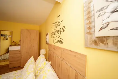 a bedroom with a bed and a sign on the wall at Antoxos Sacra Home II in Chantada