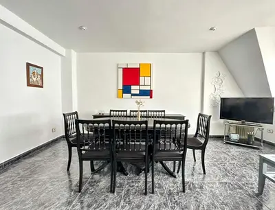 a dining room with a table and chairs and a tv at Razal in Miño