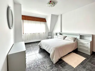 a white kitchen with white cabinets and appliances at Razal in Miño