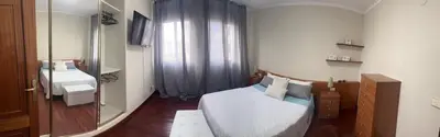 a small bedroom with a bed and a mirror at Piso pineda in Monforte de Lemos
