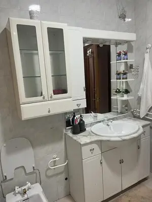 a white bathroom with a sink and a toilet at Piso pineda in Monforte de Lemos