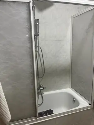 a shower with a glass door in a bathroom at Piso pineda in Monforte de Lemos