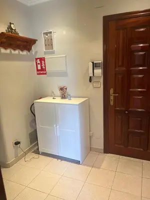a bathroom with a white sink next to a door at Piso pineda in Monforte de Lemos