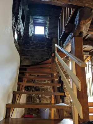 a wooden staircase in a building with a window at Casa La Parra in Villar de Vildas