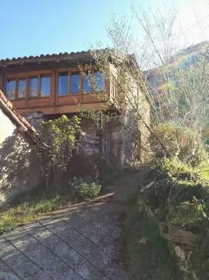 a house with a walk way in front of it at Casa La Parra in Villar de Vildas