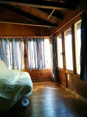 a bedroom with a bed in a room with windows at Casa La Parra in Villar de Vildas