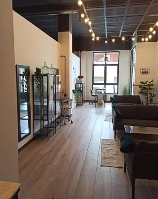 a living room with couches and a room with wooden floors at Albergue HR in Sarria