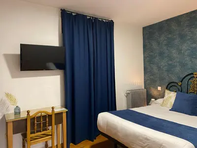a bedroom with a bed and a blue curtain at Hostal La Trucha Sanabria in Puebla de Sanabria