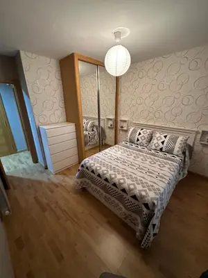 a bedroom with a bed and a pendant light at Carlos III Foz in Foz