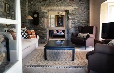 a living room with a couch and a coffee table at Villa Los Magnolios in Paderne