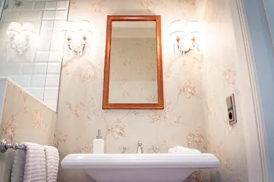 a bathroom with a sink and a mirror at Villa Los Magnolios in Paderne