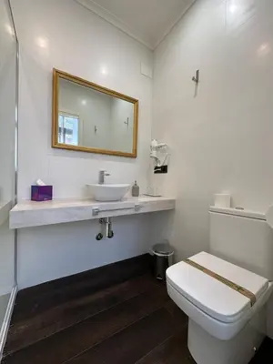 a white bathroom with a sink and a toilet at CLAREN´S BOUTIQUE ROOMS in Cangas del Narcea