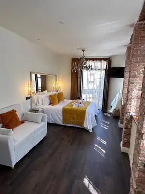 a large bedroom with a bed and a couch at CLAREN´S BOUTIQUE ROOMS in Cangas del Narcea