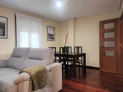 a living room with a couch and a table at 1A. Disfruta de su balcón sobre el casco viejo. in Ourense
