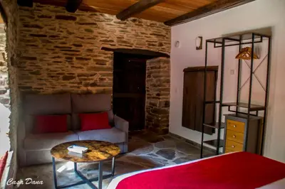 a bedroom with a couch and a table in a room at Casa Rural Dana in Castelo