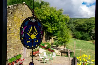 astained glass item hanging from a window of a garden at Casa Rural Dana in Castelo