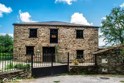an old stone building with a black fence at Casa Rural Dana in Castelo