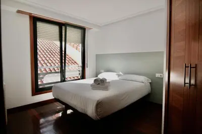 a bedroom with a bed with a towel on it at 1E.Tranquilo y soleado en la Plaza de las Mercedes in Ourense