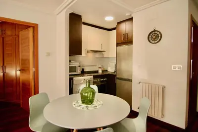 a kitchen with a table with a vase on it at 1E.Tranquilo y soleado en la Plaza de las Mercedes in Ourense