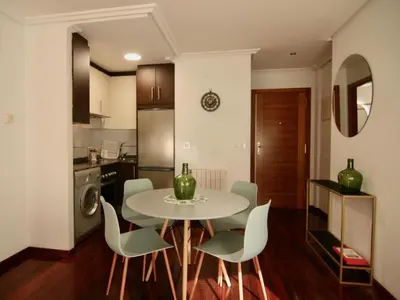 a kitchen and dining room with a table and chairs at 1E.Tranquilo y soleado en la Plaza de las Mercedes in Ourense
