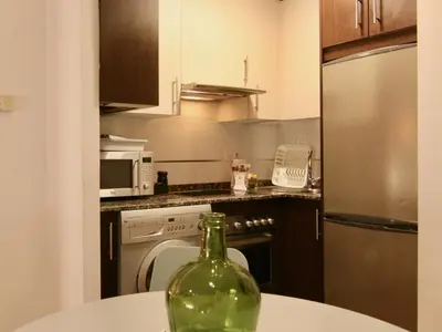 a bottle of wine sitting on a table in a kitchen at 1E.Tranquilo y soleado en la Plaza de las Mercedes in Ourense