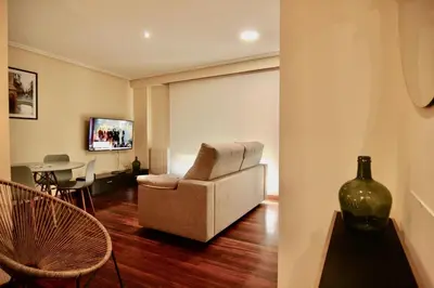 a living room with a chair and a table at 1F.Céntrico y tranquilo en la ciudad de las Burgas in Ourense